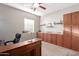 Home office with custom built-in cabinetry and a large desk at 1147 E Lodgepole Dr, Gilbert, AZ 85298