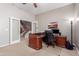 Spacious home office featuring a large desk, chair and lots of natural light at 1147 E Lodgepole Dr, Gilbert, AZ 85298