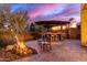 Backyard bar area with seating and a fire pit, creating an inviting outdoor living space at 1147 E Lodgepole Dr, Gilbert, AZ 85298