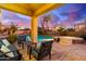 Inviting backyard oasis featuring a sparkling pool, spa, comfortable seating, and a fire pit at 1147 E Lodgepole Dr, Gilbert, AZ 85298
