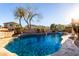 Sparkling pool featuring rock features and lush landscaping at 1147 E Lodgepole Dr, Gilbert, AZ 85298