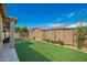Backyard with artificial grass, wall, and space for outdoor enjoyment at 11574 W Levi Dr, Avondale, AZ 85323