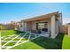 Well-manicured backyard with artificial turf, patio area, and privacy wall at 11574 W Levi Dr, Avondale, AZ 85323