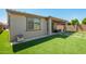 Backyard area with artificial grass, a covered patio, and a privacy fence at 11574 W Levi Dr, Avondale, AZ 85323