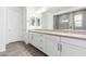 Bright Primary bathroom with double sinks, large mirrors, and a glass-enclosed shower at 11574 W Levi Dr, Avondale, AZ 85323