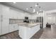 Bright and spacious kitchen with white cabinets, an island, and stainless steel appliances at 11574 W Levi Dr, Avondale, AZ 85323