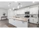 Modern kitchen featuring white cabinets, stainless steel appliances, and a large island at 11574 W Levi Dr, Avondale, AZ 85323