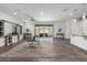 Spacious living room featuring neutral colors and wood tile flooring and large glass sliding doors at 11574 W Levi Dr, Avondale, AZ 85323