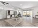 Bright living room with tile floors, a ceiling fan, and glass sliding doors at 11574 W Levi Dr, Avondale, AZ 85323