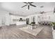 Open-concept living area with recessed lighting and tile floors flowing into dining and kitchen at 11574 W Levi Dr, Avondale, AZ 85323