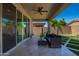 Covered patio with ceiling fan, stylish outdoor furniture, and a lush green yard at 11574 W Levi Dr, Avondale, AZ 85323