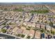 Wide aerial view showcasing a well-planned residential neighborhood with green spaces and desert surroundings at 11732 W Foothill Dr, Sun City, AZ 85373