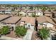 Bird's eye view showcases a two story home's roof, backyard, driveway and landscaping in a residential neighborhood at 11732 W Foothill Dr, Sun City, AZ 85373