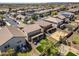 Aerial view of the backyard, the roof of the home, the driveway and other houses in the neighborhood at 11732 W Foothill Dr, Sun City, AZ 85373
