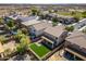 Aerial view of the backyard, the roof of the home, the driveway and other houses in the neighborhood at 11732 W Foothill Dr, Sun City, AZ 85373
