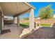An ample covered back patio and yard with synthetic grass is the perfect outdoor retreat for entertaining at 11732 W Foothill Dr, Sun City, AZ 85373