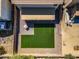 Aerial view of the backyard of a house, showcasing synthetic grass, a covered patio, and gravel landscaping at 11732 W Foothill Dr, Sun City, AZ 85373