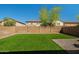 Backyard featuring artificial turf, a block wall, and rock landscaping, providing a low-maintenance and inviting outdoor space at 11732 W Foothill Dr, Sun City, AZ 85373
