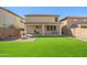 Features of the home's backyard include artificial turf, a covered patio, and gravel landscaping at 11732 W Foothill Dr, Sun City, AZ 85373
