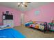 ' bedroom featuring pink walls, ceiling fan, and carpet at 11732 W Foothill Dr, Sun City, AZ 85373