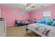 Bright bedroom with unique decor, a ceiling fan, and soft carpet at 11732 W Foothill Dr, Sun City, AZ 85373