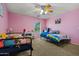 ' bedroom with pink walls, ceiling fan, carpet, and two beds at 11732 W Foothill Dr, Sun City, AZ 85373