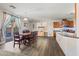 Open-concept dining room featuring wood floors, a modern table, and access to the backyard at 11732 W Foothill Dr, Sun City, AZ 85373