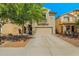 Two-story home with neutral stucco, a two-car garage, and a landscaped front yard at 11732 W Foothill Dr, Sun City, AZ 85373