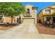 Two-story home featuring neutral stucco, a two-car garage, and desert landscaping in the front yard at 11732 W Foothill Dr, Sun City, AZ 85373