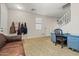 Adaptable flex room with a desk, coat rack, and staircase access, providing options for work or storage at 11732 W Foothill Dr, Sun City, AZ 85373
