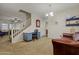 Multi-purpose flex room with a desk, couch, and easy access to stairs for enhanced versatility at 11732 W Foothill Dr, Sun City, AZ 85373