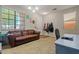 Versatile flex room with a comfortable couch, desk, and natural light, ideal for work or relaxation at 11732 W Foothill Dr, Sun City, AZ 85373