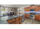 Open kitchen with island, stainless steel appliances and natural light for cooking and entertaining at 11732 W Foothill Dr, Sun City, AZ 85373
