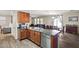 Open kitchen featuring stainless appliances, stone counters, and breakfast bar, connecting to the dining area at 11732 W Foothill Dr, Sun City, AZ 85373