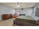 Main bedroom features gray walls, carpet flooring, and a comfortable bed at 11732 W Foothill Dr, Sun City, AZ 85373