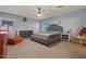 Main bedroom boasts gray walls, carpet flooring, and a comfortable bed with neutral bedding at 11732 W Foothill Dr, Sun City, AZ 85373