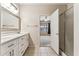 Bathroom with double sink vanity, shower, and doorway to bedroom at 1245 E Waterview Pl, Chandler, AZ 85249