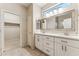 Bathroom with double sink vanity, tile floor, and framed mirror above at 1245 E Waterview Pl, Chandler, AZ 85249