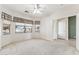 Bright bedroom with plush carpeting, neutral paint, a ceiling fan, and large windows with views of the neighborhood at 1245 E Waterview Pl, Chandler, AZ 85249
