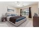 Staged bedroom with neutral colors, ceiling fan and natural light from window at 1245 E Waterview Pl, Chandler, AZ 85249