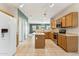 Spacious kitchen with light oak cabinets, tile floors, kitchen island, and an open view to living room at 1245 E Waterview Pl, Chandler, AZ 85249
