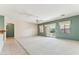 Spacious living room with plush carpet, neutral walls, a ceiling fan, and sliding glass doors to the backyard at 1245 E Waterview Pl, Chandler, AZ 85249
