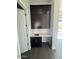 A modern butler pantry featuring dark cabinets, counter space, and a sink adds convenience and elegance at 13382 E Sand Hills Rd, Scottsdale, AZ 85255