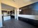 An open space dining room featuring wood floors, contemporary light fixture, and cabinets with white countertops at 13382 E Sand Hills Rd, Scottsdale, AZ 85255