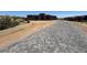Long driveway made of gray pavers leading up to a modern home, surrounded by desert landscape at 13382 E Sand Hills Rd, Scottsdale, AZ 85255