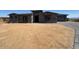 Elegant home with a desert landscape and a two-car garage, displaying a contemporary design at 13382 E Sand Hills Rd, Scottsdale, AZ 85255