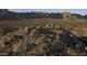 An aerial view showcases natural rock formations and desert vegetation under clear blue sky at 13382 E Sand Hills Rd, Scottsdale, AZ 85255