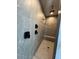Luxurious walk-in shower with gray stone tile and multiple shower heads with a built in bench at 13382 E Sand Hills Rd, Scottsdale, AZ 85255