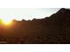 Desert landscape view with sun rising over mountain range in the distance at 13382 E Sand Hills Rd, Scottsdale, AZ 85255