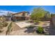 Expansive backyard featuring a large patio, desert landscaping, and mature tree at 13416 S 47Th St, Phoenix, AZ 85044